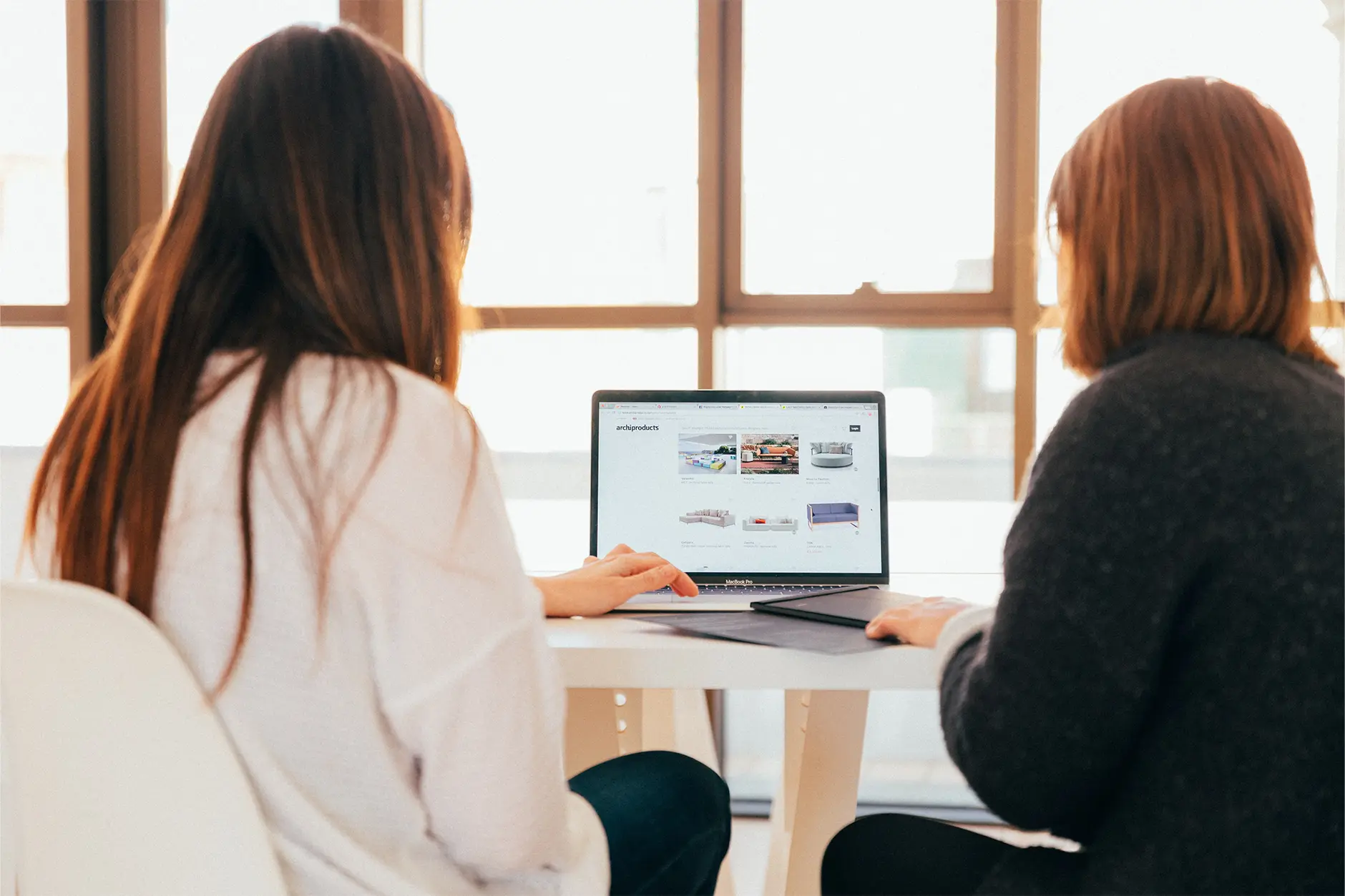 Two people reviewing a web design